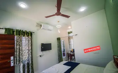a bedroom with a bed and a ceiling fan at ARUL Residency in Mettuppālaiyam