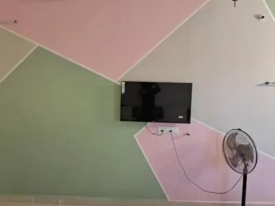 a room with a flat screen tv and a fan at ARUL Residency in Mettuppālaiyam