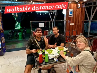 a group of people sitting at a table eating food at ARUL Residency in Mettuppālaiyam