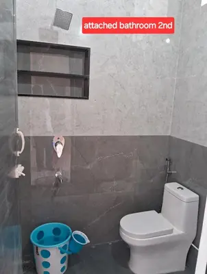 a bathroom with a toilet and a sign that reads attached bathroom at ARUL Residency in Mettuppālaiyam