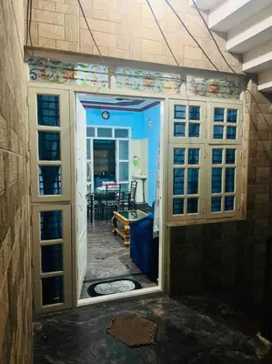 a room with a door open to a living room at Dreamy bungalow 2BHK apartment in Mysore