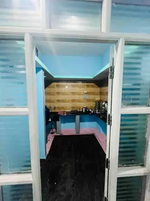 an open door to a room with a kitchen at Dreamy bungalow 2BHK apartment in Mysore
