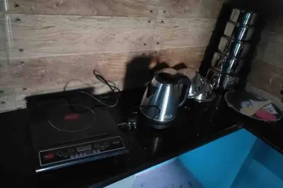 a tea pot sitting on top of a stove at Dreamy bungalow 2BHK apartment in Mysore