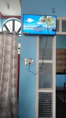 a wall with a tv on top of a door at Dreamy bungalow 2BHK apartment in Mysore