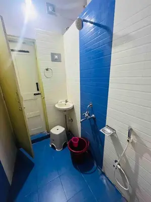 a blue and white bathroom with a sink and a toilet at Dreamy bungalow 2BHK apartment in Mysore