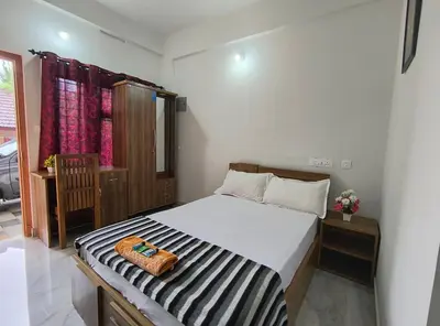 a bedroom with a bed with a purse on it at GREEN FIELDS Apartments in Mananthavady