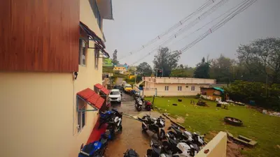 a group of motorcycles parked next to a building at Hidden doors in Ooty
