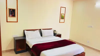 a bedroom with a bed with white sheets and pillows at Hidden doors in Ooty