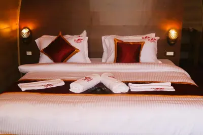 a bedroom with two beds with towels and pillows at Royal Adventures in Kodaikānāl