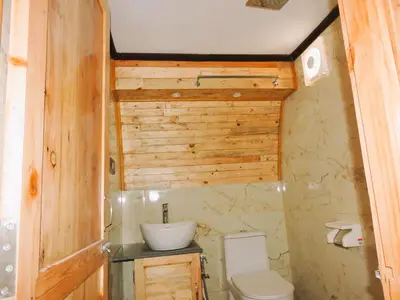 a bathroom with a toilet and a sink at Royal Adventures in Kodaikānāl