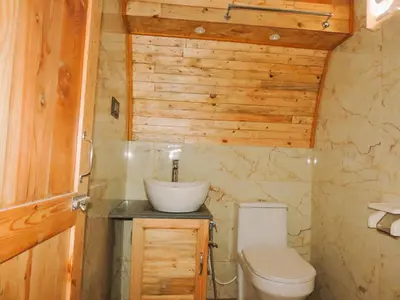 a bathroom with a sink and a toilet at Royal Adventures in Kodaikānāl