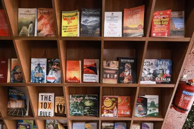 a book shelf with books on it at Thanima Farmlife experiential Farm Tourism in Nallepilli