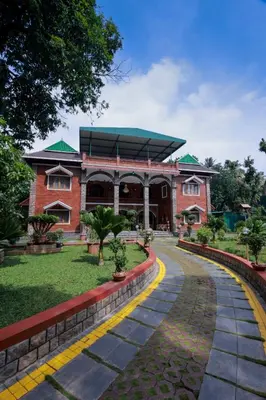 a red brick building with a walkway in front of it at Thanima Farmlife experiential Farm Tourism in Nallepilli