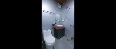 a white bathroom with a toilet and a sink at Thanima Farmlife experiential Farm Tourism in Nallepilli