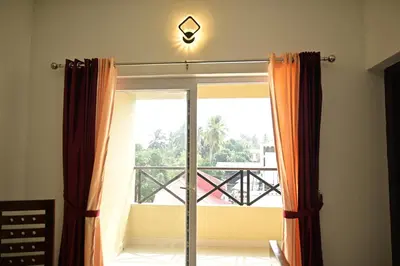 a window with a view of a balcony at Geetham Villas in Palakkad