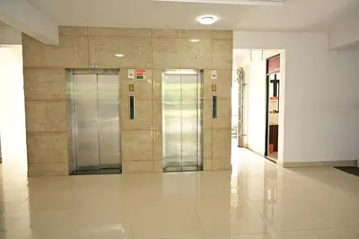 a hallway with two elevators in a building at Geetham Villas in Palakkad