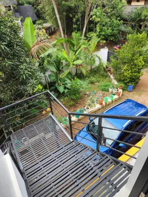 a metal bed with a pool in a garden at Olive Home stay Gold 1bhk in Alwaye
