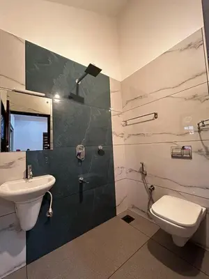 a bathroom with a sink and a toilet at Windgram Homestay in Ambalavayal