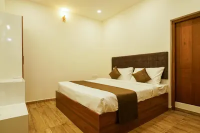 a bedroom with a large bed in a room at Grand Plaza Inn in Kottakkal