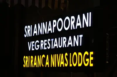 a sign that reads spamernooren vaccine restraint and emergencylegate at Sri Ranga Nivas in Palani