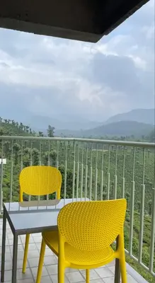 two yellow chairs and a table on a balcony at BEL VISTO in Vālpārai