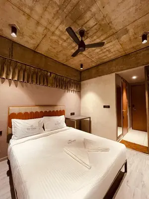 a bedroom with a bed with a ceiling fan at BEL VISTO in Vālpārai