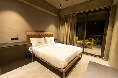 a bedroom with a bed and a large window at BEL VISTO in Vālpārai