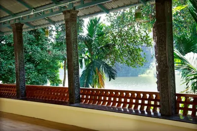 a balcony with a view of the water at Nisarga Ayurveda in Kizhake Chālakudi