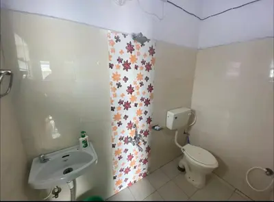 a bathroom with a toilet and a shower curtain with stars at Roof top couple stay cozy in Mysore