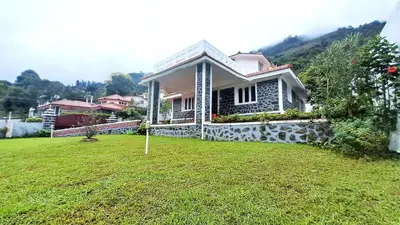 a small house in a yard with a green lawn at iSTAYS - Kodai Villa in Kodaikānāl