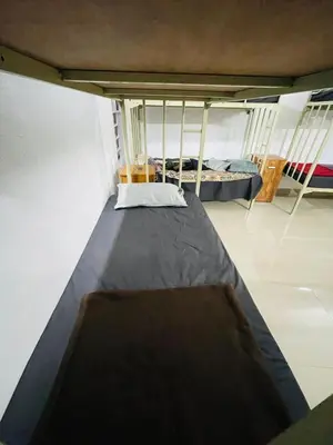 a room with two bunk beds in a room at Queen C Inn Wayanad in Mānantoddy