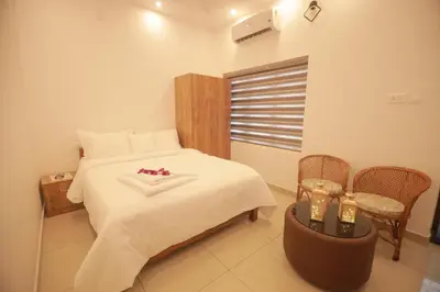 a bedroom with a bed with a heart pillow on it at Humblebee Retreat Tattekkad in Kuttampuzha