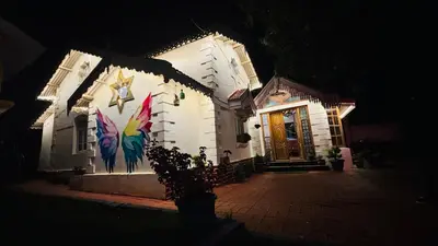 a building with a painting on the side of it at night at Hidden heritage ins in Ooty