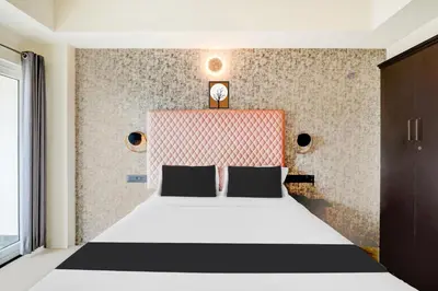 a bedroom with a bed with a black and white at Super Townhouse Mysore Central in Mysore