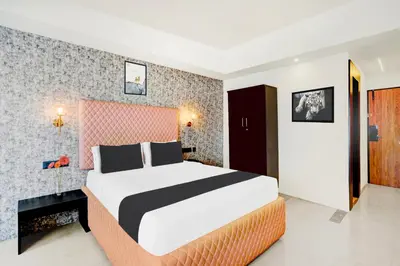 a bedroom with a large bed in a room at Super Townhouse Mysore Central in Mysore