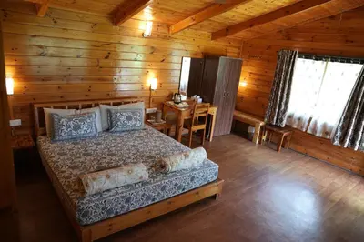 a bedroom with a bed in a wooden cabin at labdhi Resorts Masinagudi- Stag Groups not allowed in Masinagudi