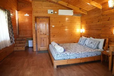 a bedroom with a bed in a wooden cabin at labdhi Resorts Masinagudi- Stag Groups not allowed in Masinagudi