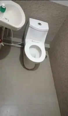 a bathroom with a white toilet and a sink at Renu Residency near Maruthamalai and on the way to Adiyogi Isha yoga Centre in Marudhamalai