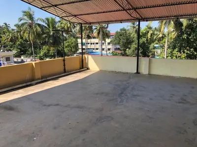 an empty parking lot in a building with palm trees at Angel Valley in Trichūr