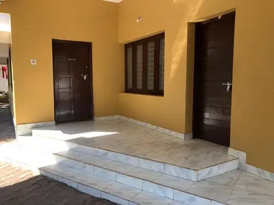 two doors on the side of a house at Angel Valley in Trichūr