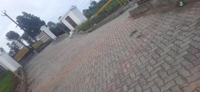 a brick wall with a fence on top of it at COASTAL GRAND RESORT - KOTAGIRI in Kotagiri