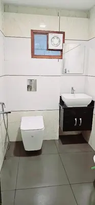 a bathroom with a toilet and a sink at Hotel Royal Wings in Elūr