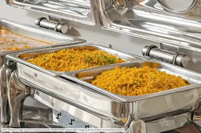 two metal trays of food in a buffet at Treebo ESS Grande in Coimbatore