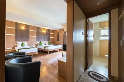 a living room with a couch and a table at Treebo ESS Grande in Coimbatore