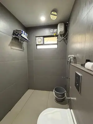 a small bathroom with a toilet and a window at Feel Free Retreat in Kalpetta