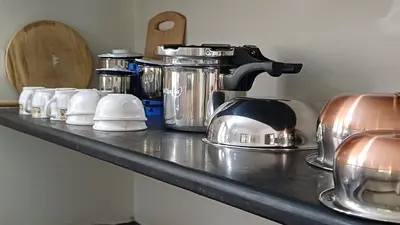 a counter top with a coffee maker and appliances on it at SHI's Velliangiri 3BHK Individual villa Near Isha Adiyogi, Coimbatore in Alāndurai
