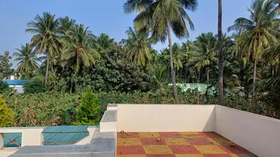 a resort with palm trees and a swimming pool at SHI's Velliangiri 3BHK Individual villa Near Isha Adiyogi, Coimbatore in Alāndurai