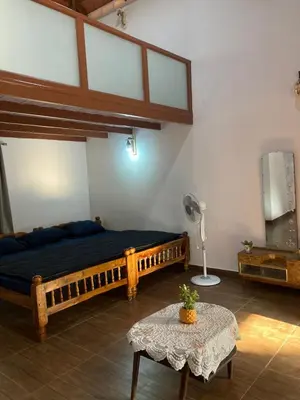 a bedroom with a large bed and a table at Coorg klusters estate stay in Virajpet