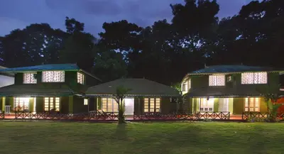 a house at night with the lights on at Elephant Pass Ayurveda & Yoga Retreat in Malayāttūr