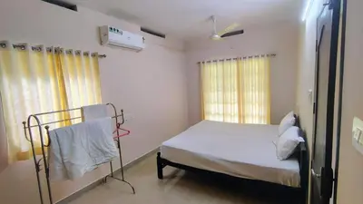 a hospital room with a bed and a window at Elephant Pass Ayurveda & Yoga Retreat in Malayāttūr
